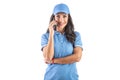 Attractive dark-haired delivery woman in blue uniform calling to a customer. Isolated background Royalty Free Stock Photo