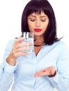 Attractive Dark Haired Young Woman Holding a Glass and Taking Medicine