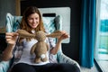 Attractive delighted pregnant pretty European woman, future mum in anticipation of baby plays with plush cuddly rabbit toy, enjoys