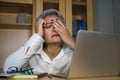 Attractive depressed and sad mature Asian business woman working at office computer desk feeling stressed and overwhelmed