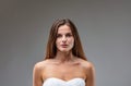 Attractive, determined young woman in white strapless dress