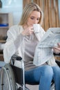 attractive disabled woman reading business newspaper in office Royalty Free Stock Photo