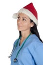 Attractive doctor woman with Christmas cup thinkin