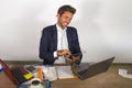 Attractive and efficient business man working at office laptop computer desk confident in smiling happy using calculator accountin Royalty Free Stock Photo