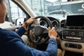 Elegant happy man in good new car in sale centre Royalty Free Stock Photo