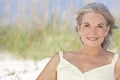 Attractive Elegant Senior Woman Sitting At A Beach