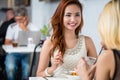 Attractive elegant woman lunching with a friend