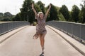 Attractive jubilant blond woman on a bridge