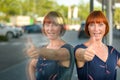 Attractive enthusiastic redhead woman giving a thumbs up