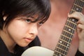 Attractive Ethnic Girl Plays Guitar