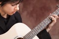 Attractive Ethnic Girl Plays Guitar