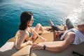 Happy couple lying on a boat at sea. Luxury vacation on a yacht in the islands. Royalty Free Stock Photo