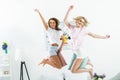 attractive excited girls jumping with pillows