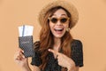 Attractive excited woman 20s wearing straw hat and sunglasses sm