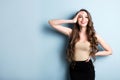 Attractive excited young woman wearing casual clothing standing isolated over blue background