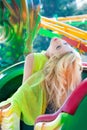 Attractive fashion beautiful blonde woman in elegant yellow dress in amusement park summer Royalty Free Stock Photo