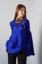 Attractive fashion model in blue silk blouse with butterfly sleeves Royalty Free Stock Photo