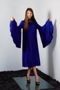 Attractive fashion model in blue silk dress with butterfly sleeves Royalty Free Stock Photo