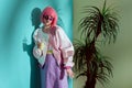 attractive fashionable girl in pink wig holding disposable cup with smoothie Royalty Free Stock Photo