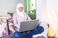 Attractive female Arabic working on laptop computer and paperwork`s on desk. Muslim Businesswoman working at home. Dedication and Royalty Free Stock Photo