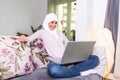 Attractive female Arabic working on laptop computer and paperwork`s on desk. Muslim Businesswoman working at home. Dedication and Royalty Free Stock Photo