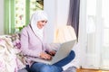 Attractive female Arabic working on laptop computer and paperwork`s on desk. Muslim Businesswoman working at home. Dedication and Royalty Free Stock Photo