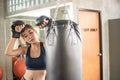 Attractive female boxer training with kick boxing at gym with blackgloves Royalty Free Stock Photo