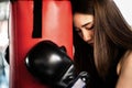 Attractive female boxer training with kick boxing at gym with blackgloves Royalty Free Stock Photo