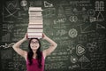 Attractive female bring books on her head at class Royalty Free Stock Photo