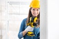 Attractive Female Builder drilling a hole