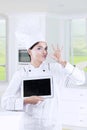 Attractive female chef with tablet in kitchen Royalty Free Stock Photo