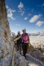 Attractive female climbers on a steep Via Ferrata in the Italian Dolomites