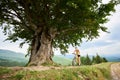 Attractive female cyclist with yellow mountain bicycle, enjoying sunny day in the mountains Royalty Free Stock Photo