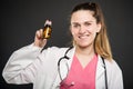 Attractive female doctor holding bottle of pills Royalty Free Stock Photo