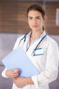 Attractive female doctor holding papers Royalty Free Stock Photo