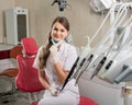 Attractive female doctor with microscope in the modern dentist office Royalty Free Stock Photo