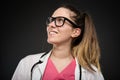 Attractive female doctor portrait wearing glasses looking up Royalty Free Stock Photo