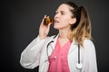 Attractive female doctor taking bottle of pills Royalty Free Stock Photo