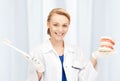 Attractive female doctor with toothbrush and jaws Royalty Free Stock Photo