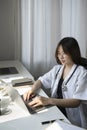 Female doctor is working with documents and laptop in her medical office. Royalty Free Stock Photo