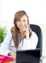 Attractive female doctor working with a laptop Royalty Free Stock Photo