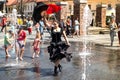 Attractive female Flamenco dancers in the square among the fountain well