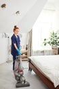 Floor care and cleaning services with vacuume cleaner at hotel room