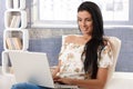 Attractive female with laptop computer smiling