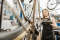 Attractive female mechanic renovating the bicycle