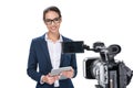 attractive female newscaster with digital tablet standing in front of camera,