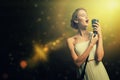 Attractive female singer with microphone Royalty Free Stock Photo