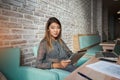 Attractive female sitting with portable net-book in coffee shop