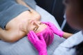 Attractive female at spa health club getting a facial massage. Beautician doing massage of face, neck and shoulders Royalty Free Stock Photo