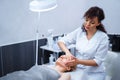 Attractive female at spa health club getting a facial massage. Beautician doing massage of face, neck and shoulders Royalty Free Stock Photo